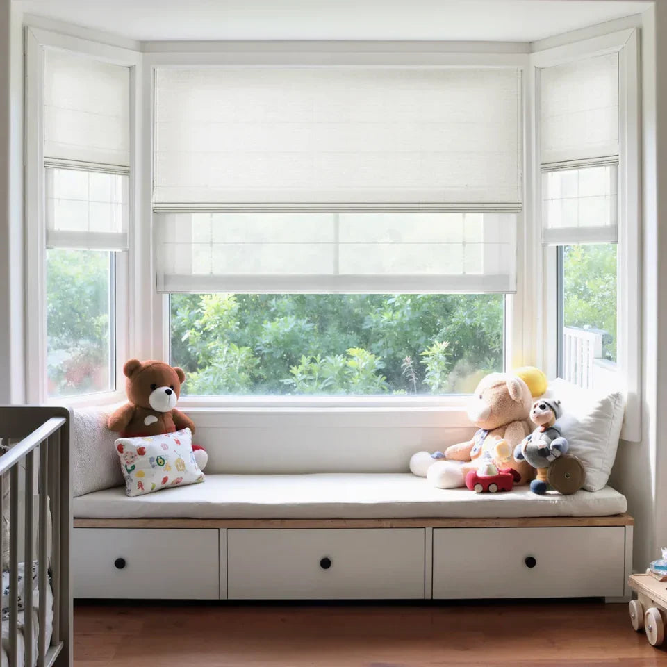 Children's window seat with stuffed animals and pillows in a bright room.