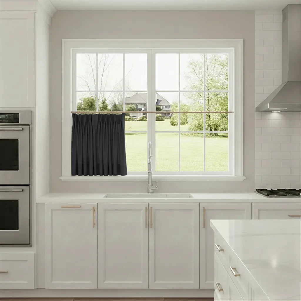 Modern kitchen with a window view of a green lawn and trees