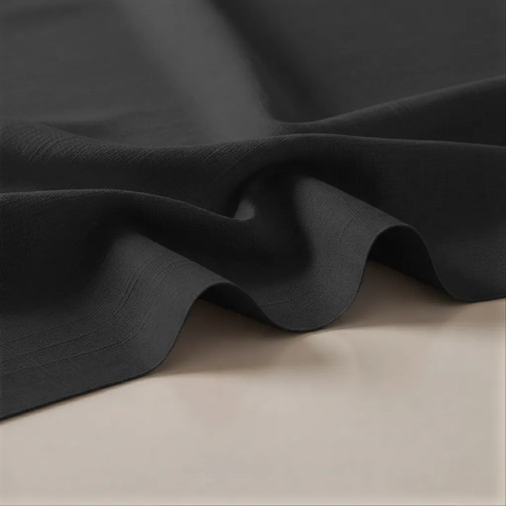 Dark gray fabric draped over a beige surface