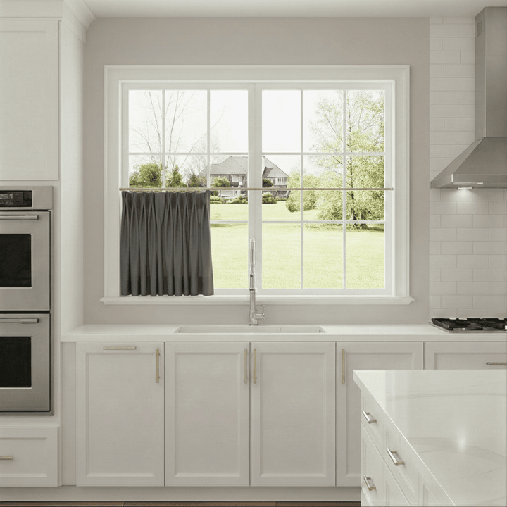 Modern kitchen with a window view of a house and trees