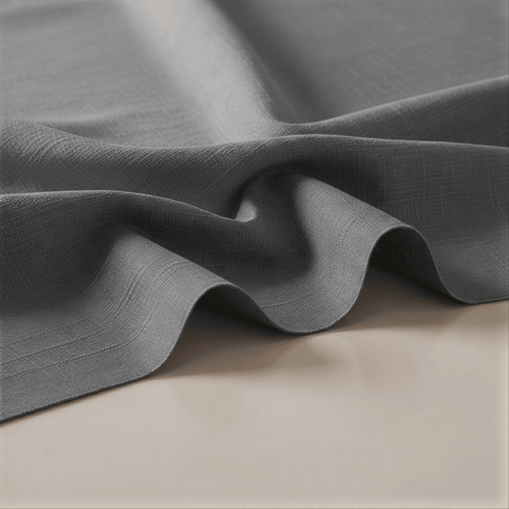 Close-up of gray fabric with a textured surface on a beige background