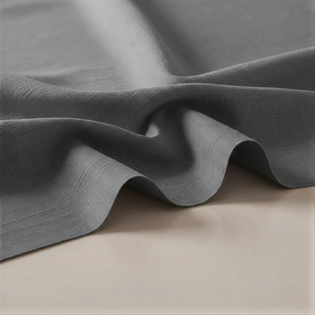 Close-up of gray fabric with a textured surface on a beige background