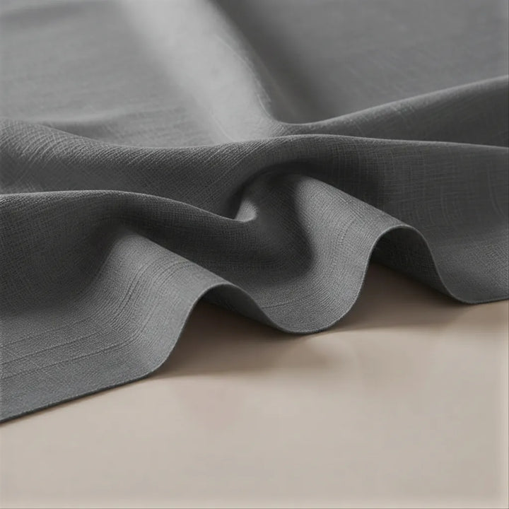 Close-up of gray fabric with a textured surface on a beige background