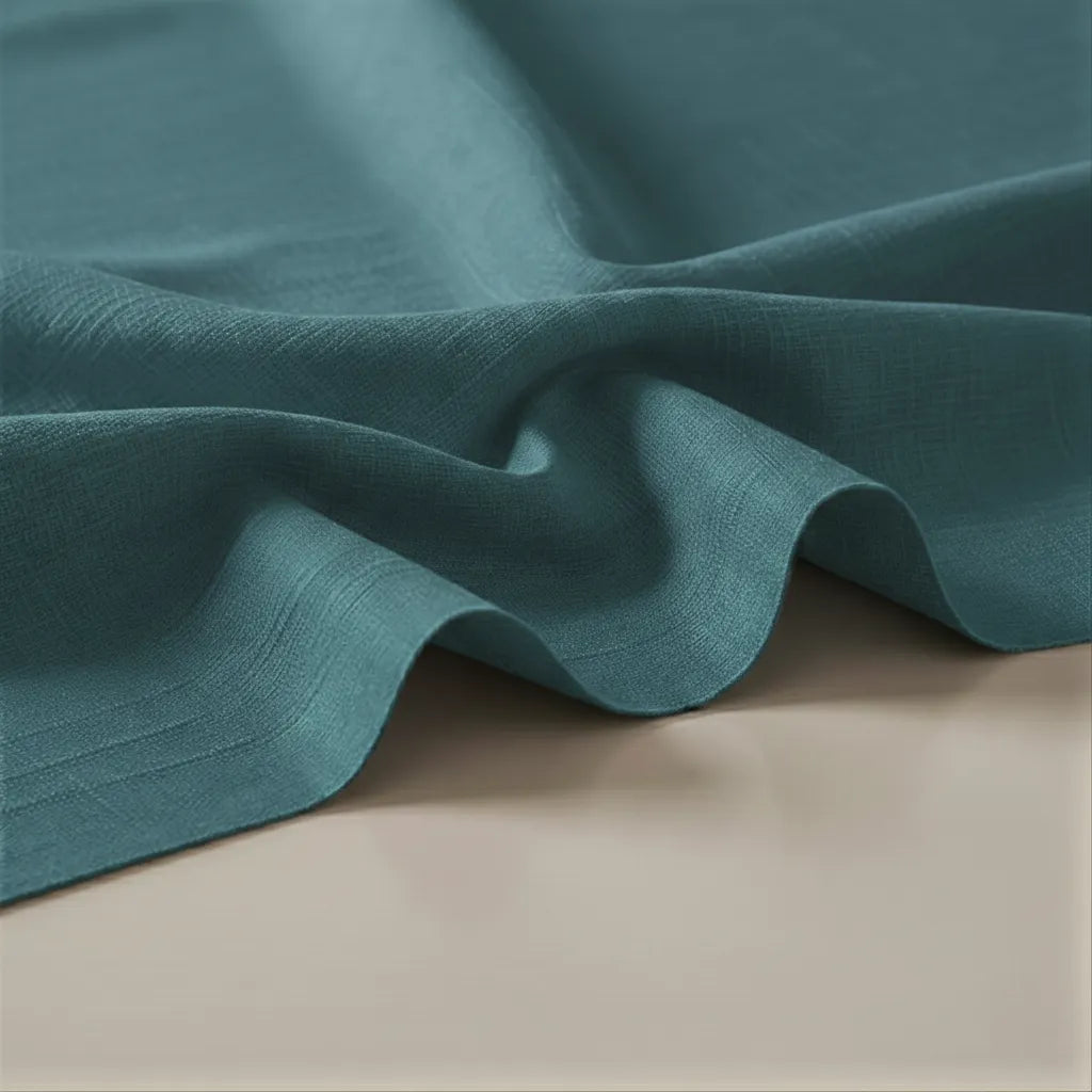 Close-up of teal fabric on a beige surface