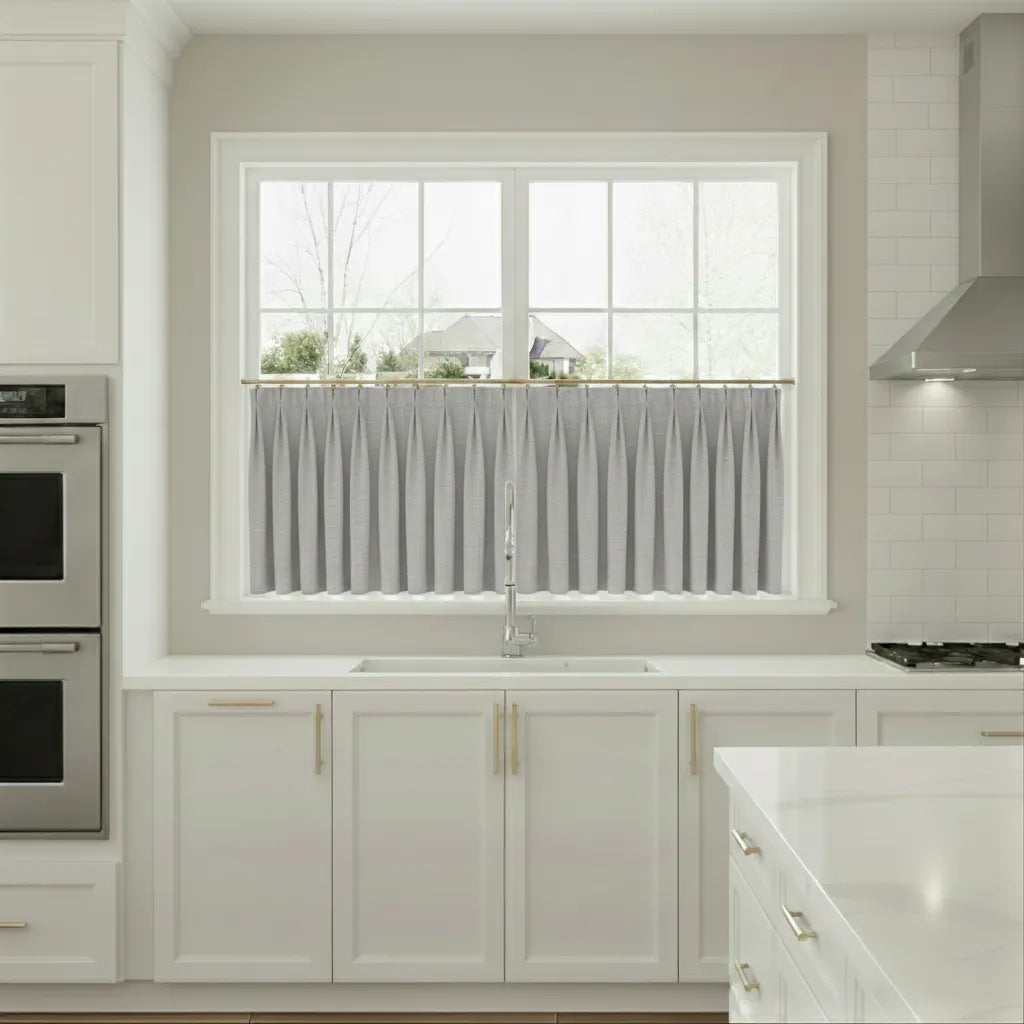 Modern kitchen with white cabinets, a window, and stainless steel appliances.