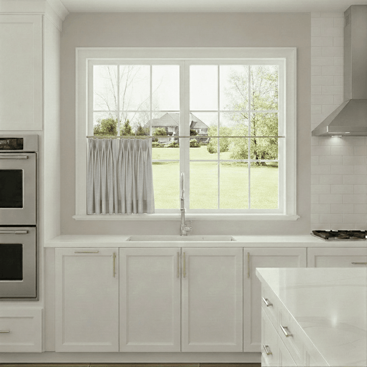 Modern kitchen with a window view of a house and trees