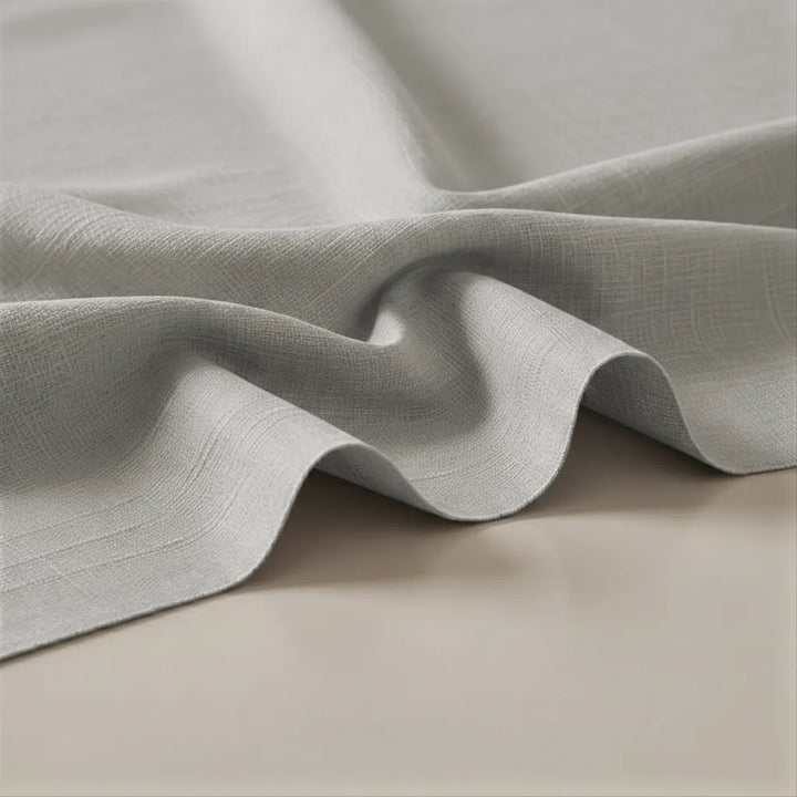 Close-up of textured gray fabric on a beige surface