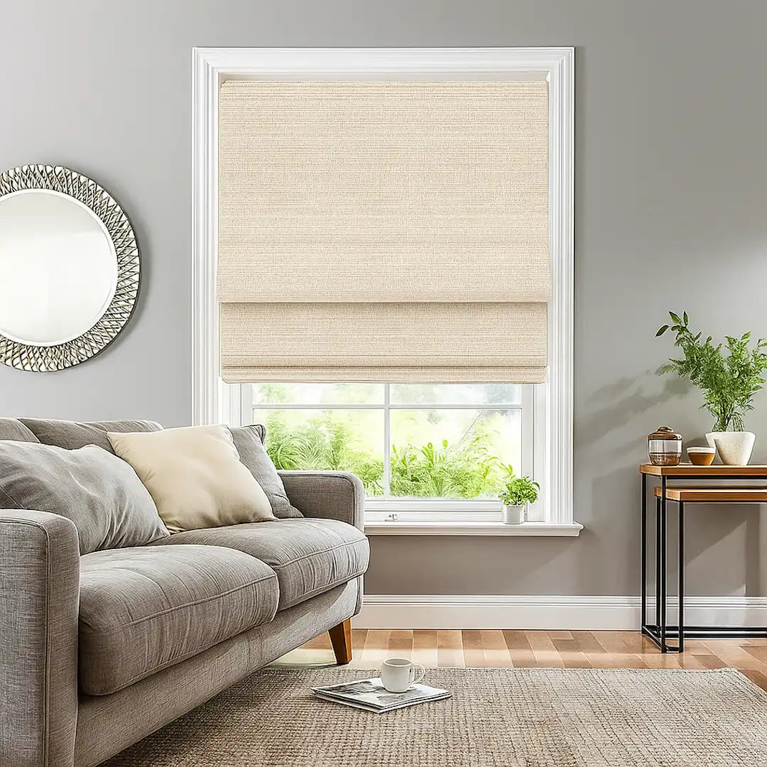 Living room window with beige Roman shade above a grey sofa