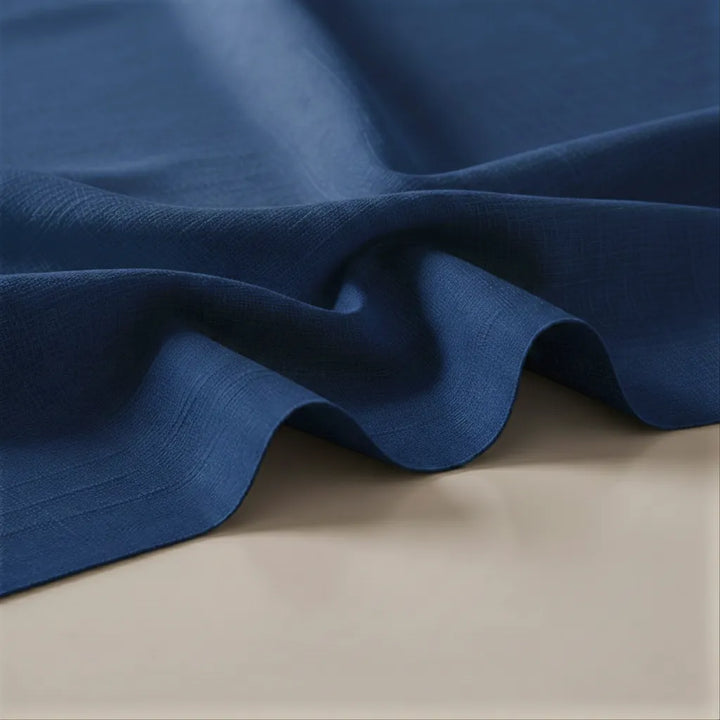 Close-up of blue fabric on a beige surface