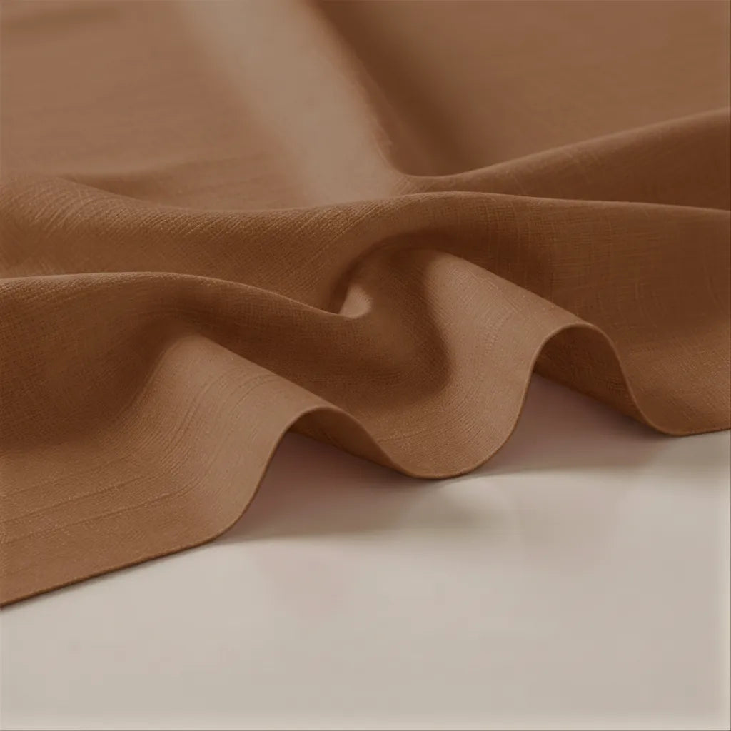 Close-up of brown fabric with folds on a beige background