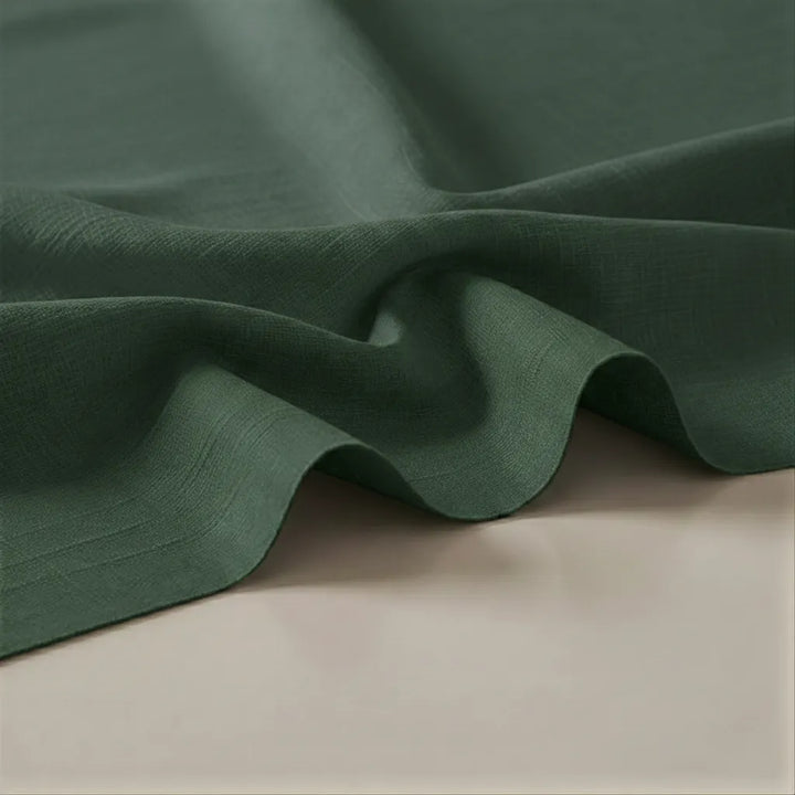 Close-up of green fabric on a beige surface
