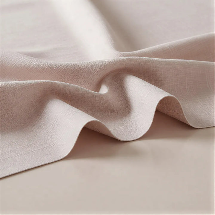 Close-up of beige fabric with soft folds on a matching background