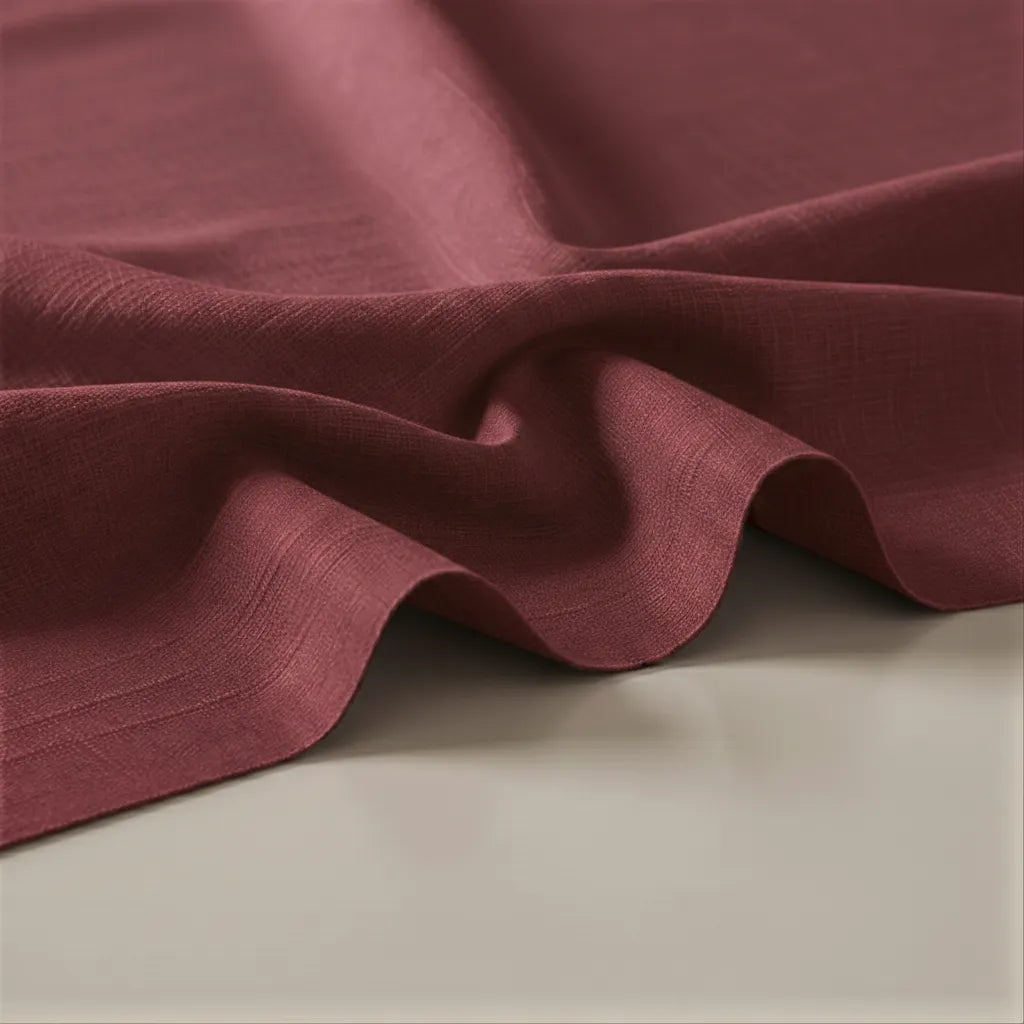 Close-up of maroon fabric on a beige surface