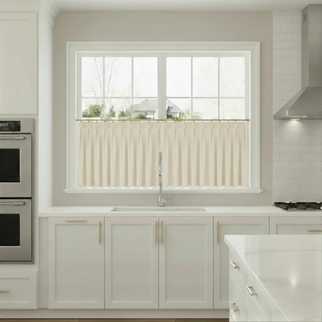 Modern kitchen with white cabinets, a window, and stainless steel appliances.
