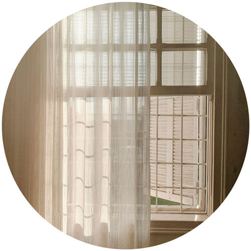 Window with sheer curtains and blinds